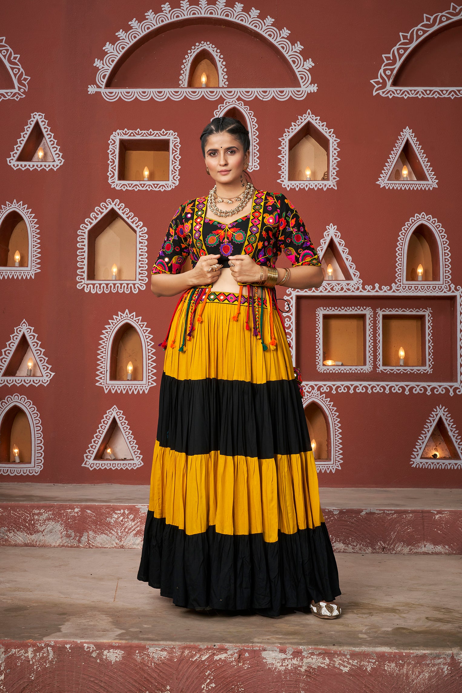 Mustard and black tiered Chaniya Choli with floral embroidered jacket