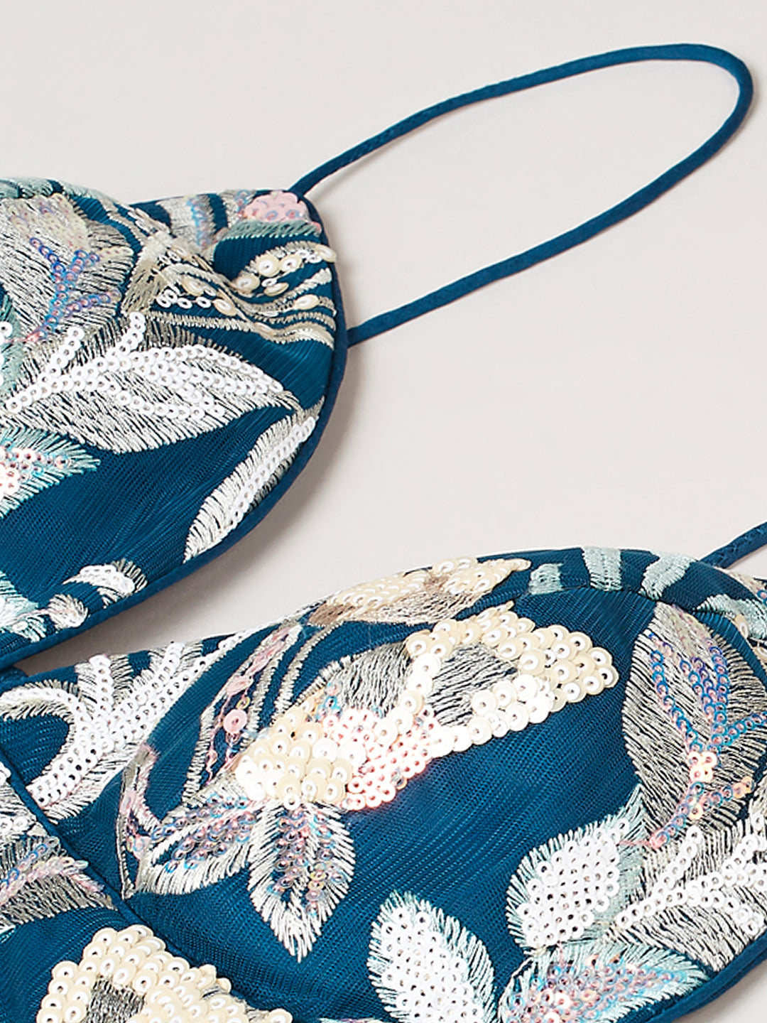 Close-up of sequins cutwork border on navy lehenga
