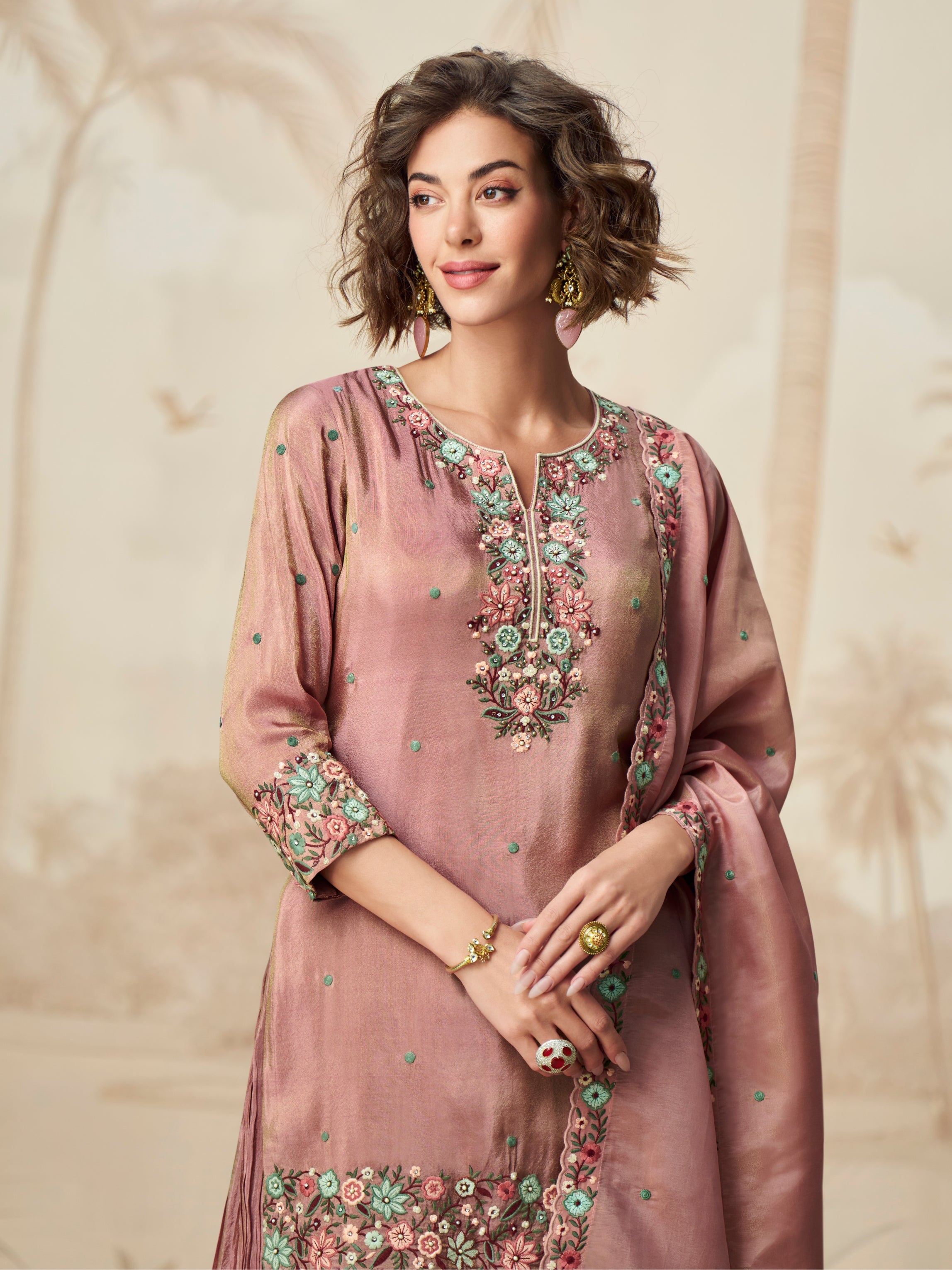 Close-up of floral embroidery on mauve suit