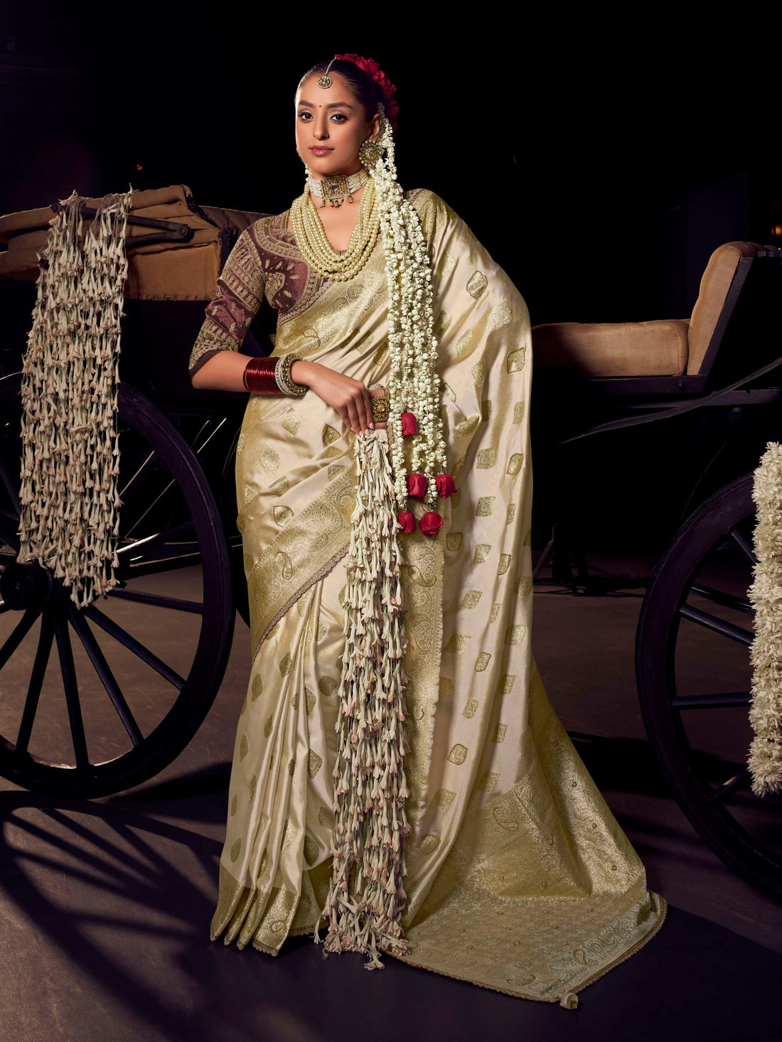 Cream and gold Banarasi saree with maroon contrast heavy embroidered blouse