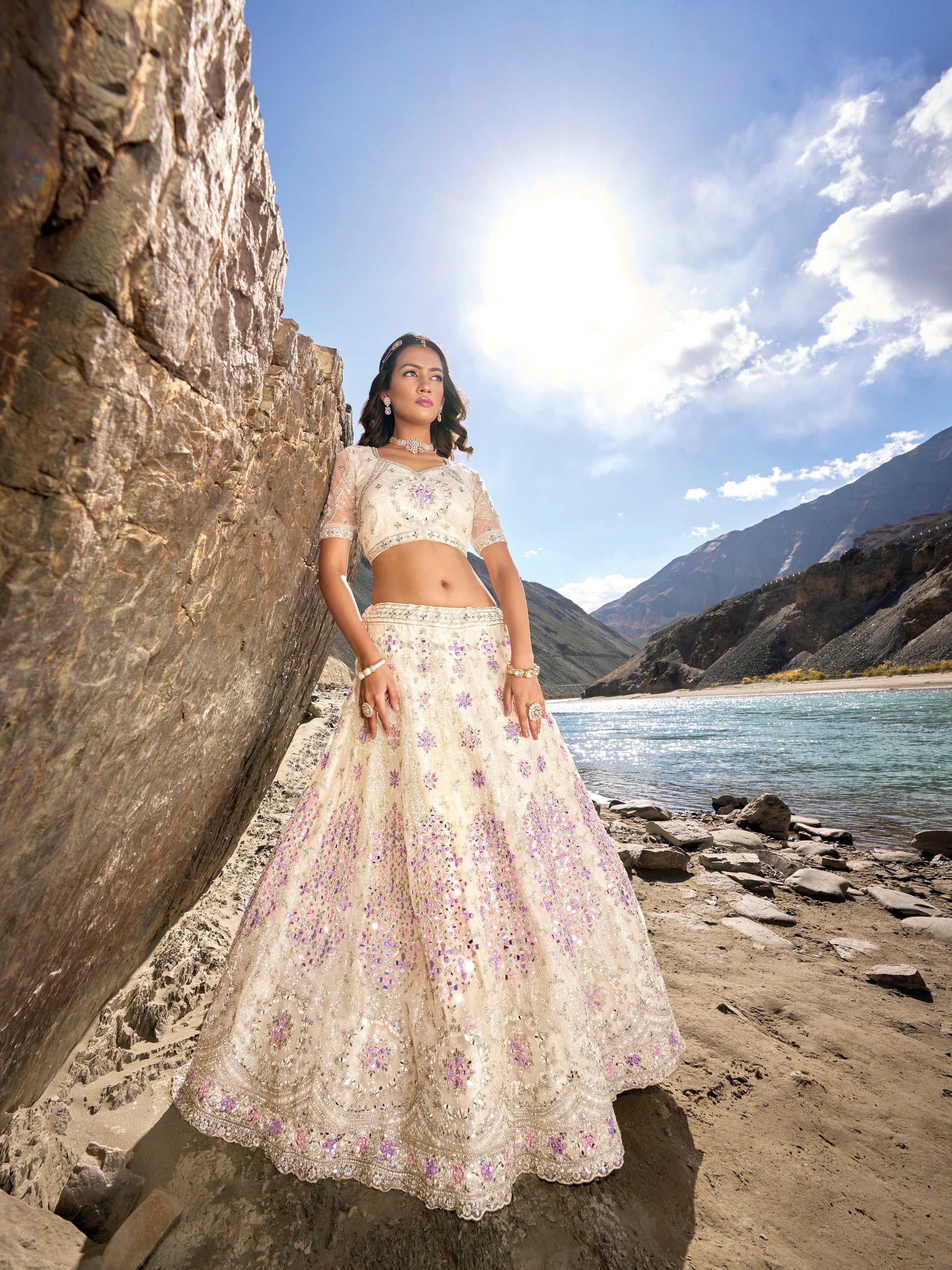 Off-white bridal lehenga choli with purple floral embellishments