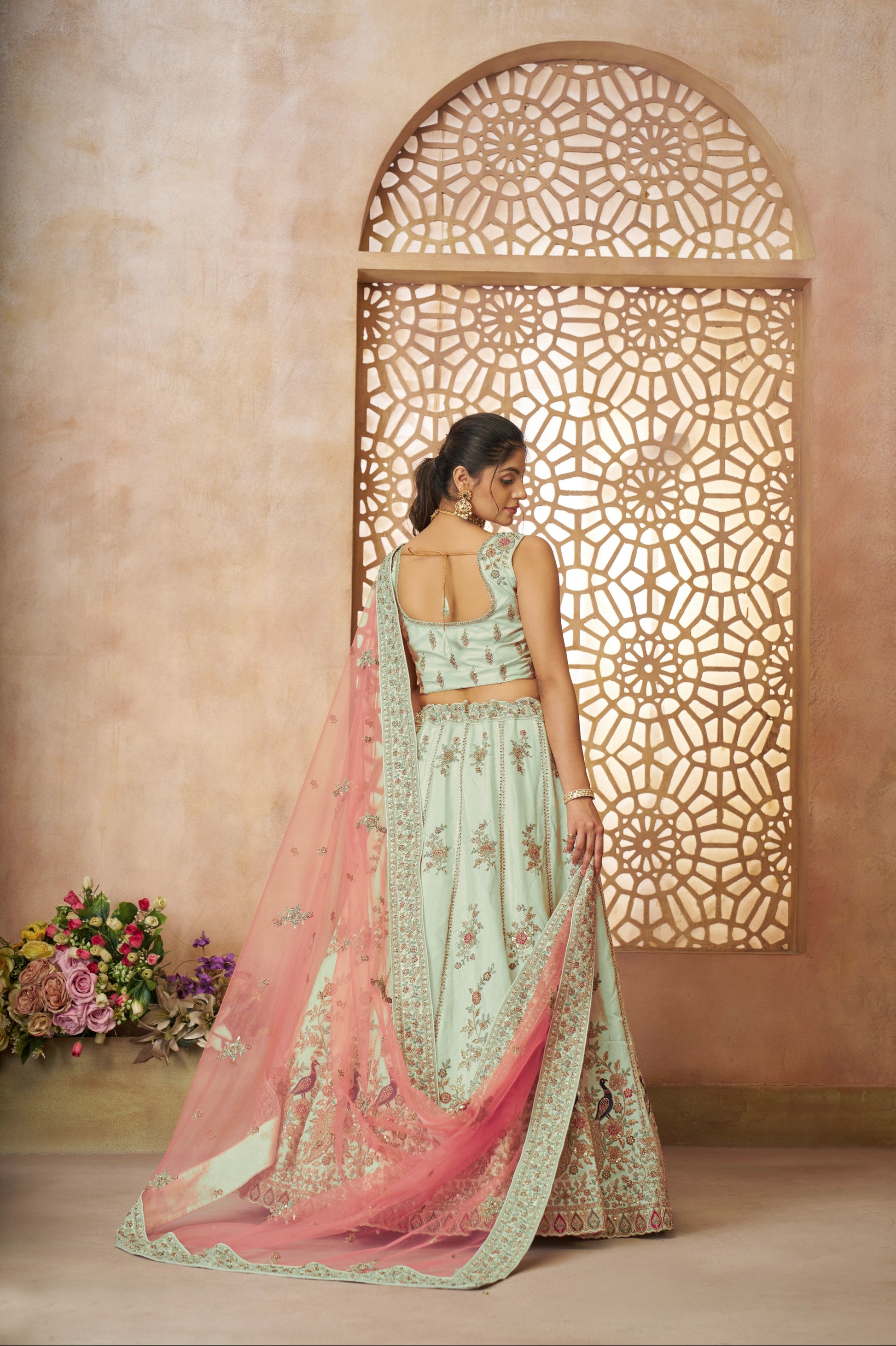 Traditional Indian bridal lehenga in green zari silk with royal peacock design