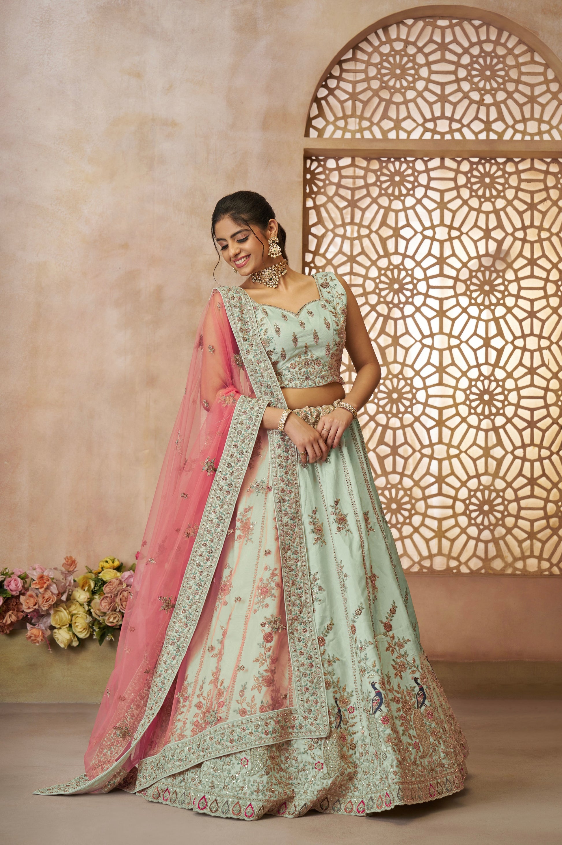 Green zari silk bridal lehenga with intricate peacock embroidery and traditional detailing