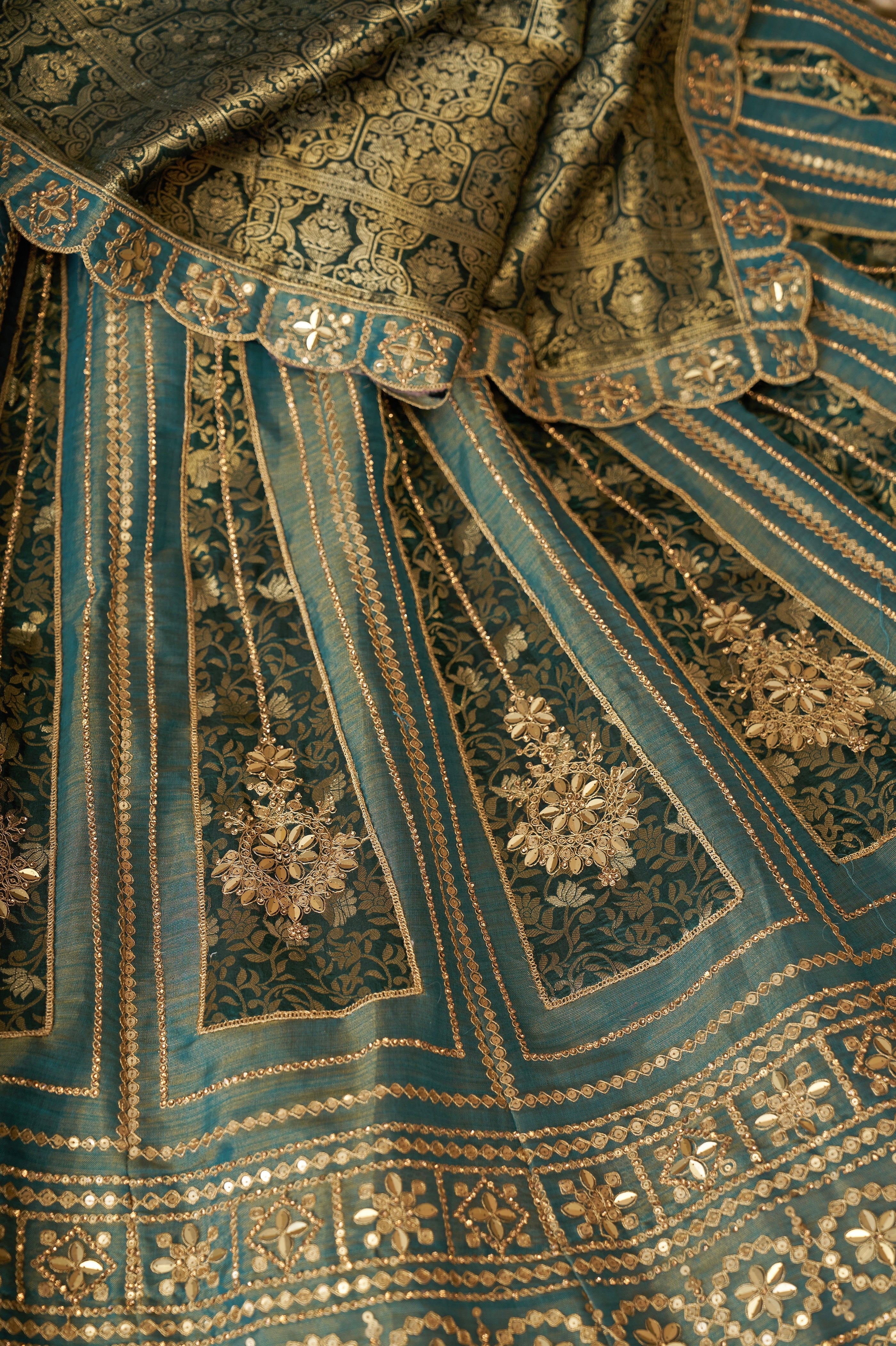 Close-up of zari work on green bridal lehenga