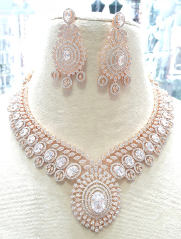 Rose gold necklace with clear stones and earrings