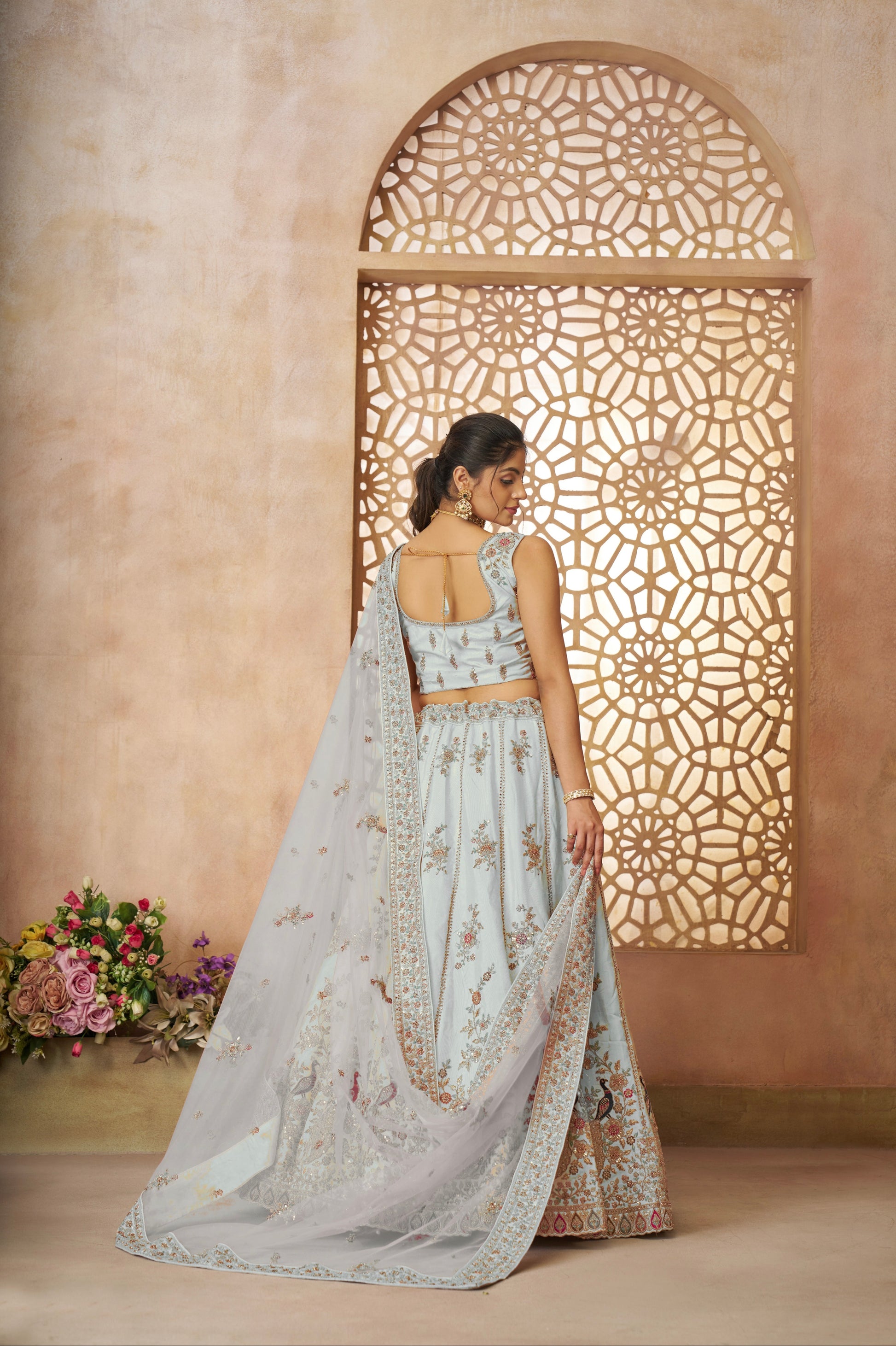 Elegant sky blue wedding lehenga in zari silk with royal peacock design accents