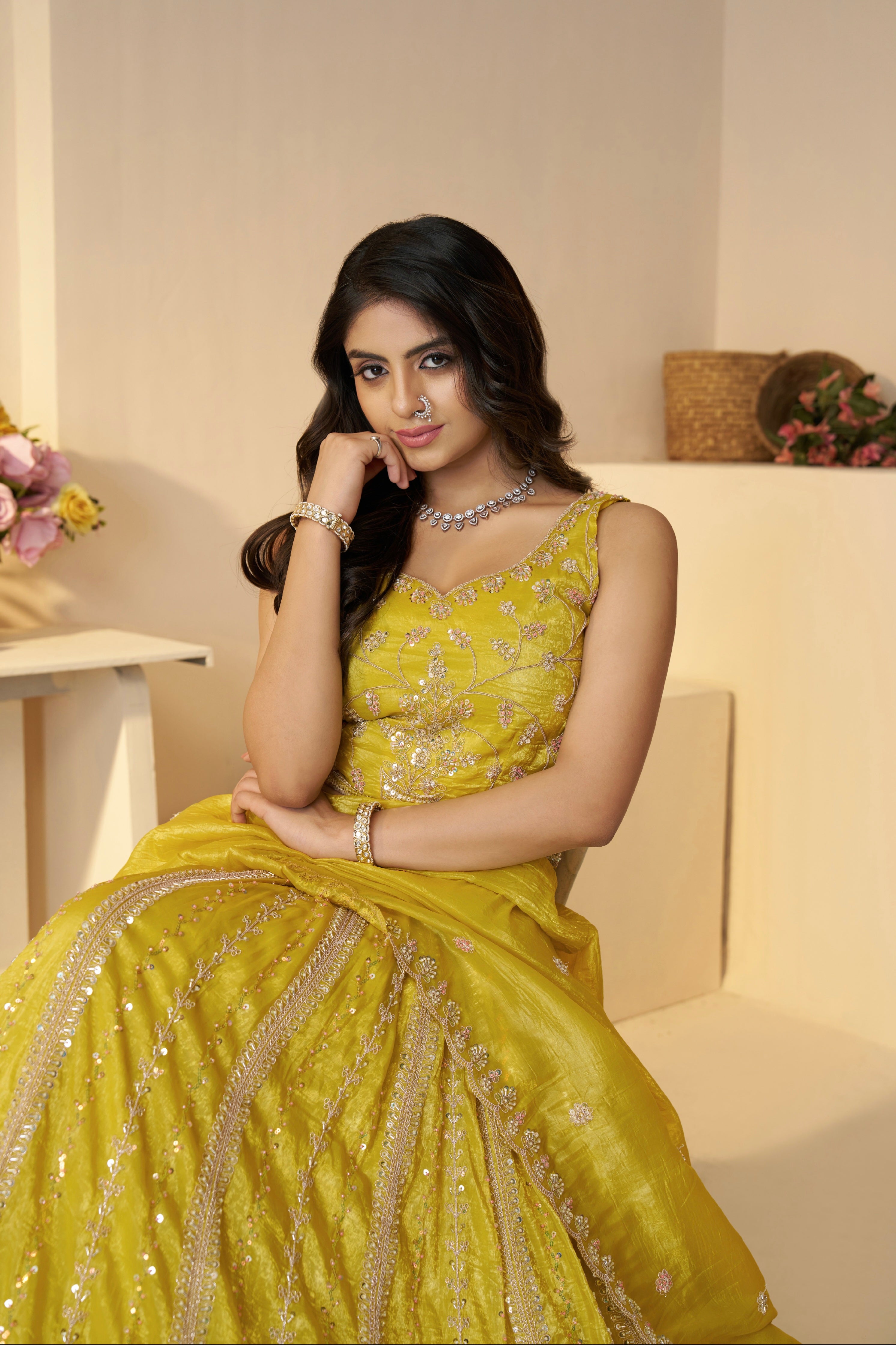 Close-up of intricate stone work on yellow bridal lehenga