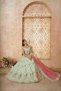 Heavy green zari silk bridal lehenga adorned with colorful peacock threadwork