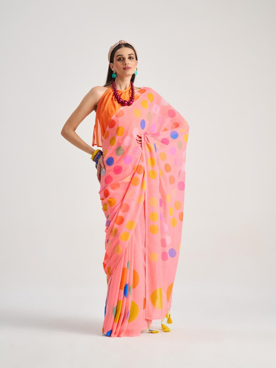 Bright pink georgette saree with yellow dots
