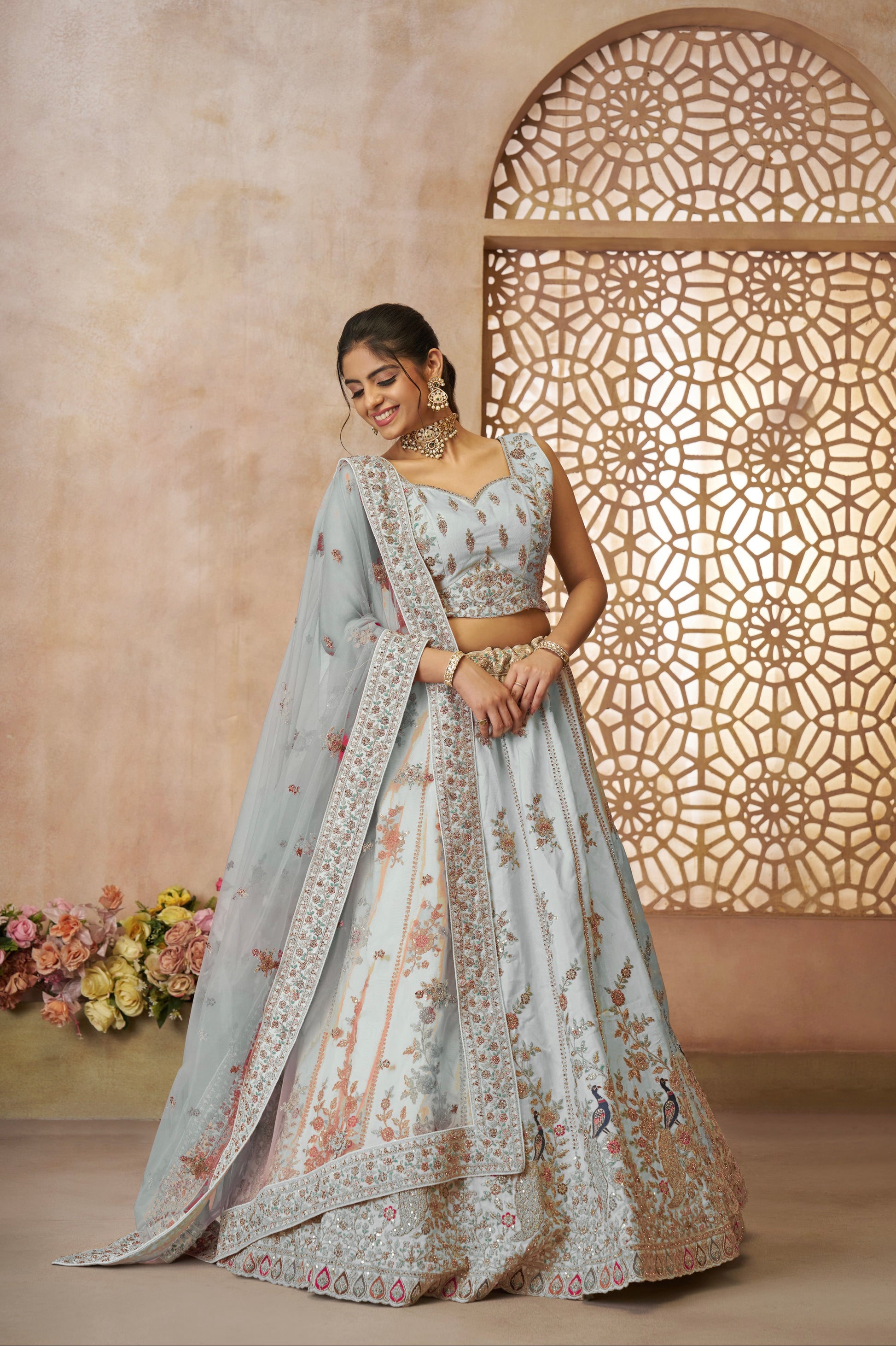 Sky blue zari silk bridal lehenga featuring elegant peacock motifs and detailed embroidery