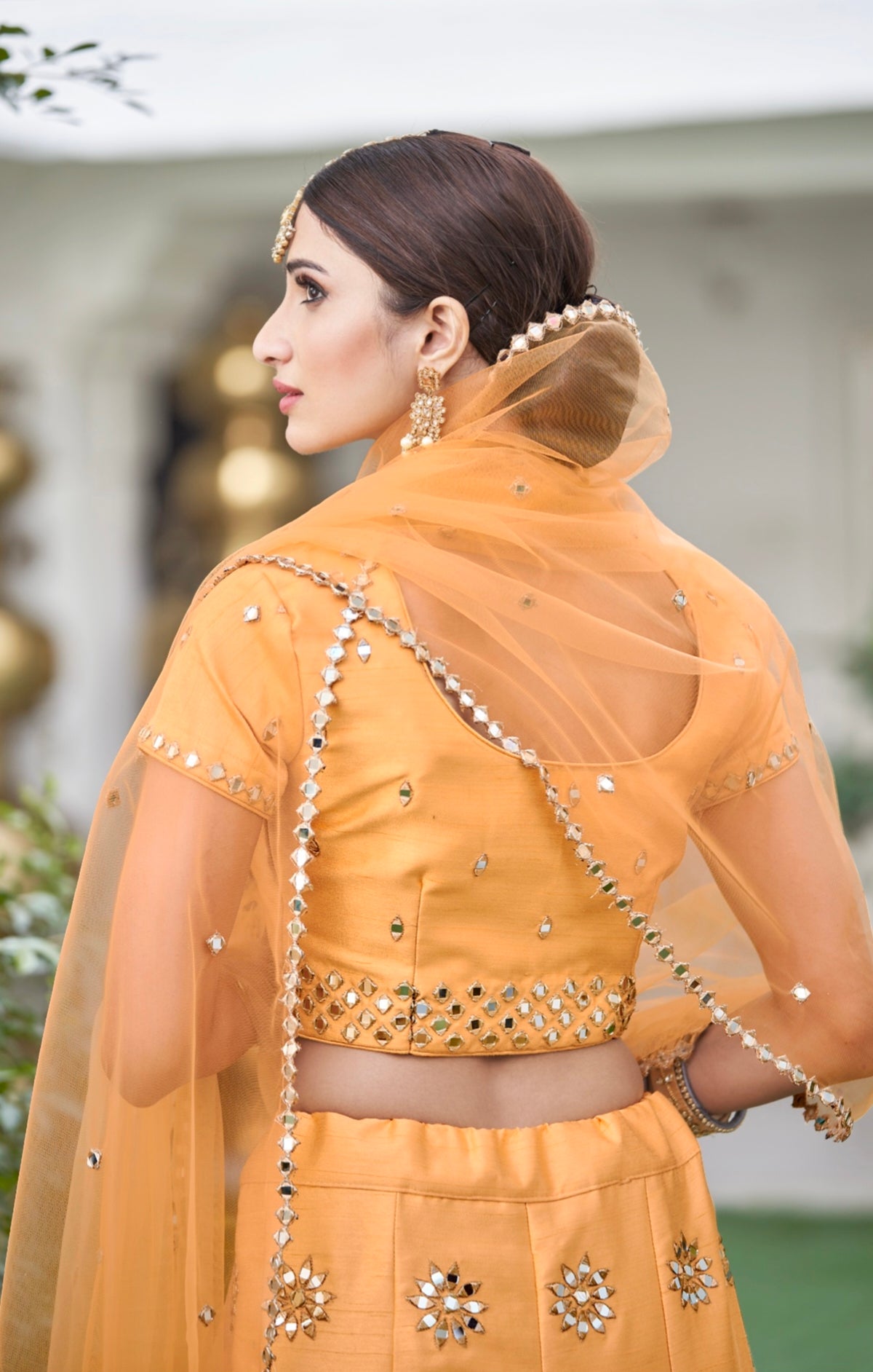 Back view of mustard mirror work blouse and dupatta