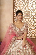 Elegant white bridal lehenga in silk with contrasting pink net dupatta