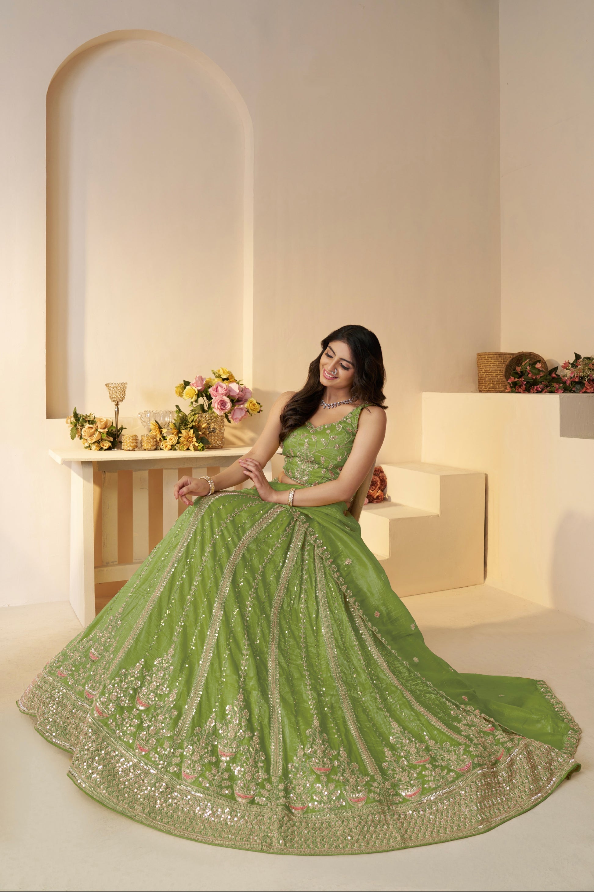 Front view of heavily embellished green bridal lehenga