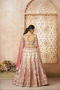 Heavy embroidered white silk lehenga with soft pink bridal dupatta