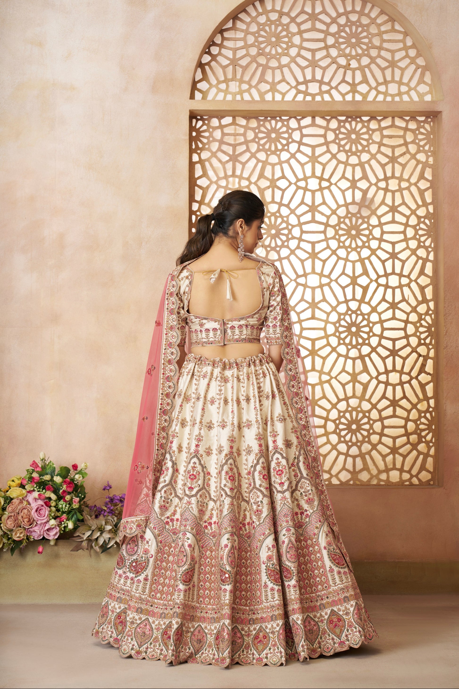 Heavy embroidered white silk lehenga with soft pink bridal dupatta