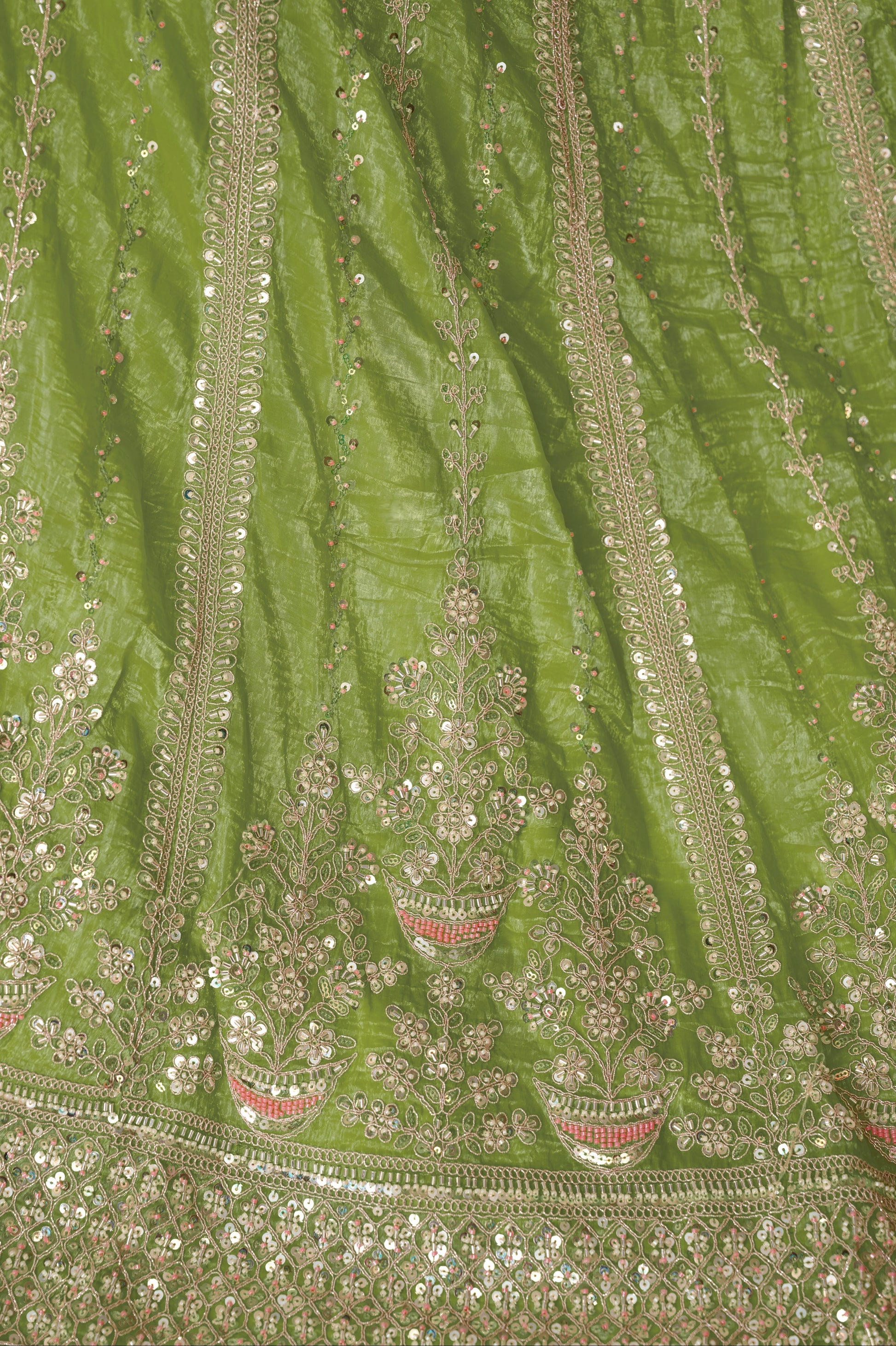 Close-up of embroidery on green lehenga skirt and blouse
