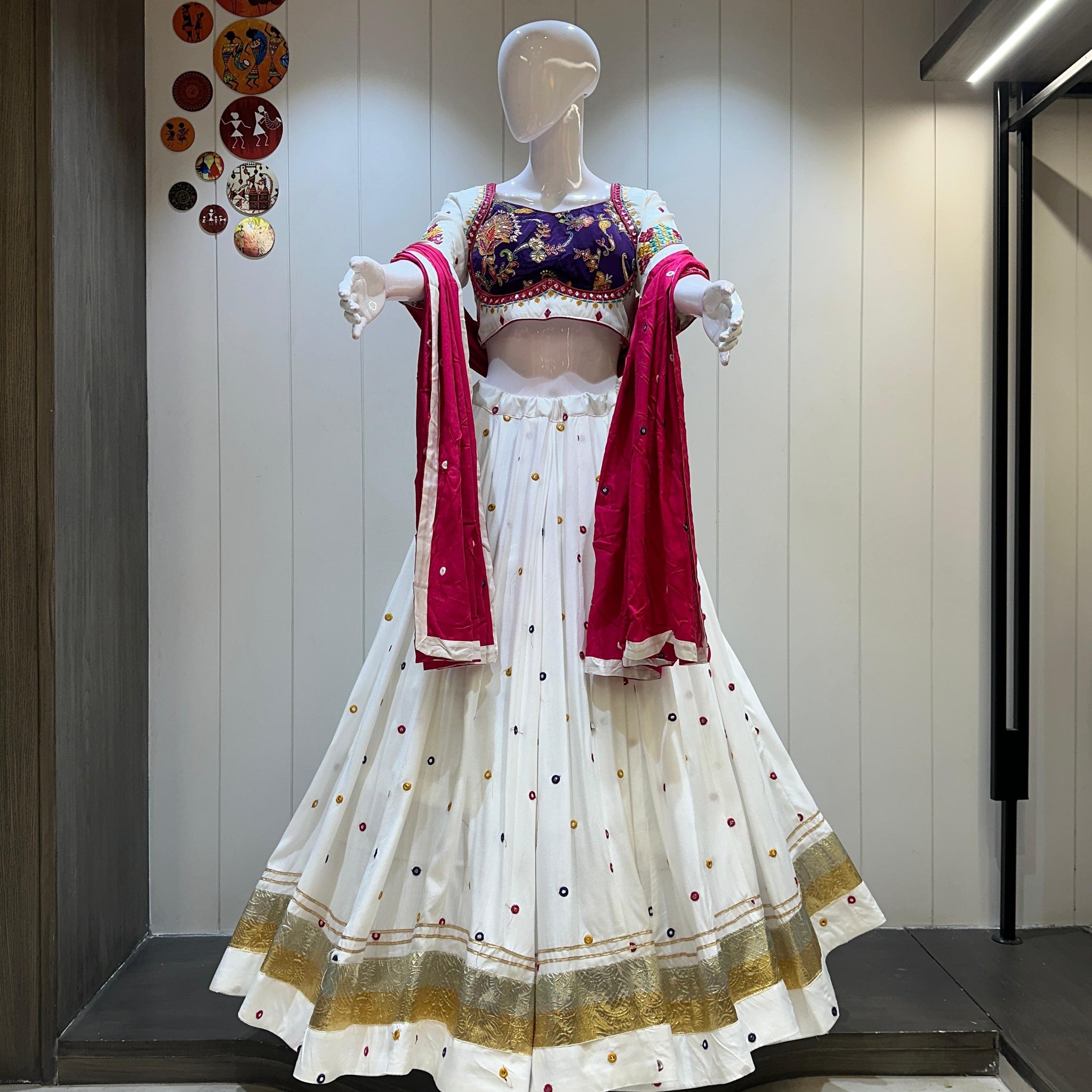 White chaniya choli with red dupatta and gold detailing


