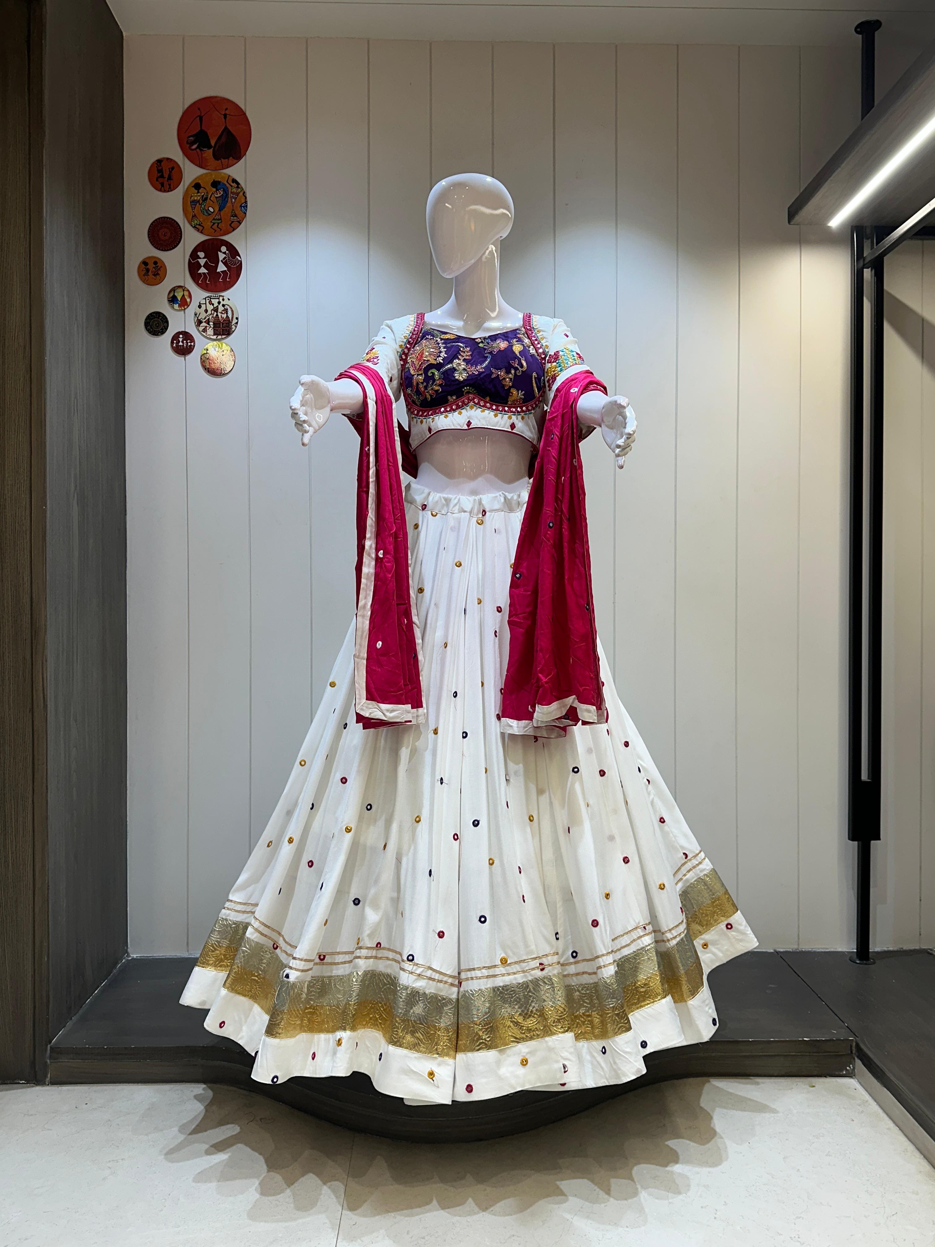 White chaniya choli with red dupatta and gold detailing

