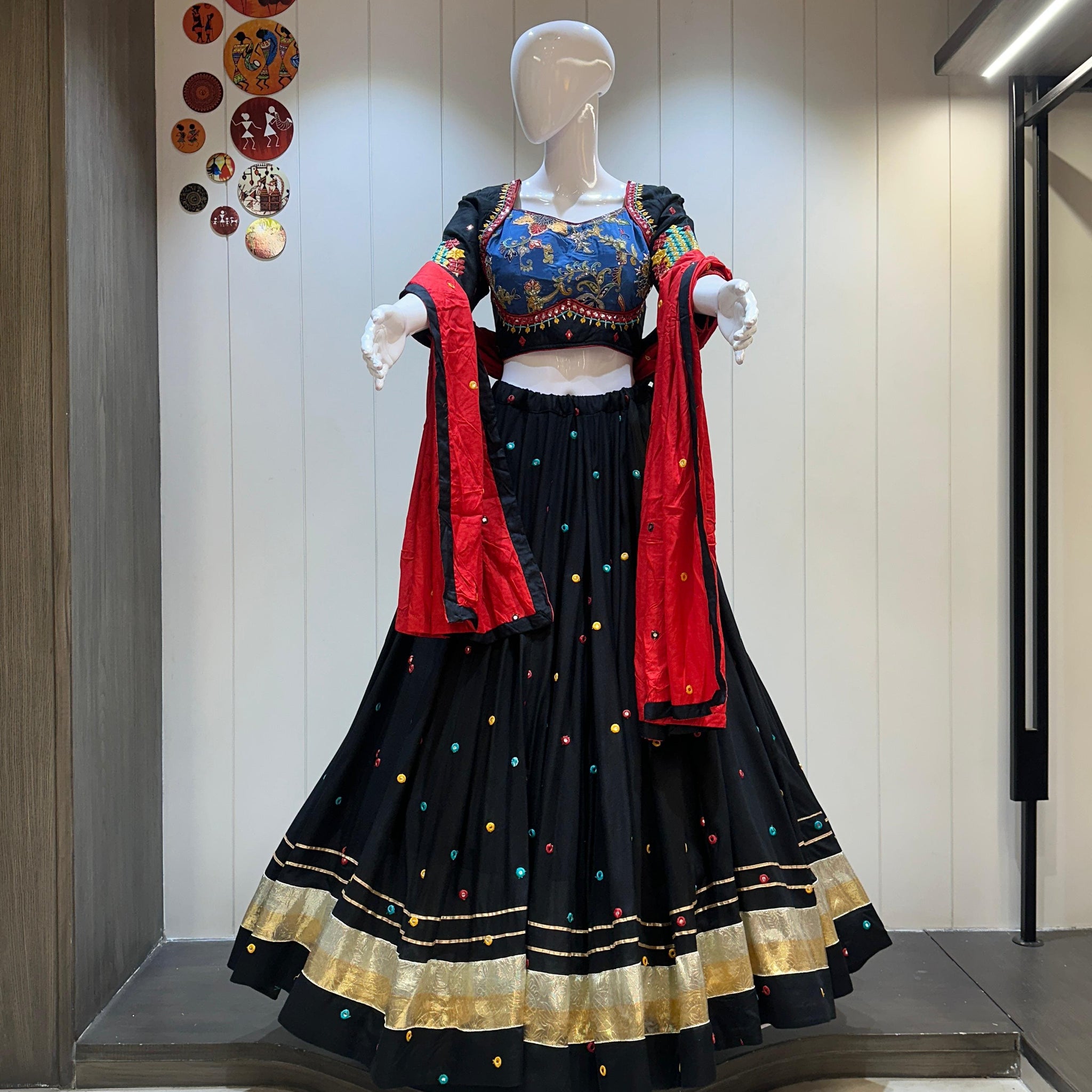 Black chaniya choli with red dupatta and gold trim

