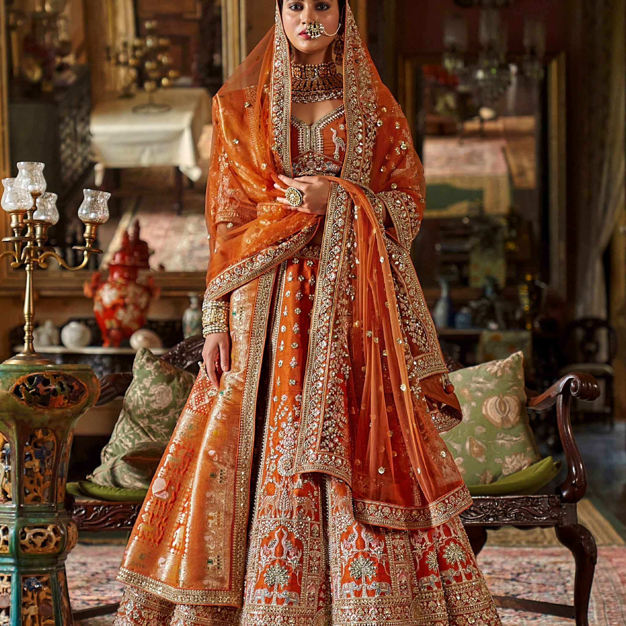 Designer orange lehenga with zari weaving and pearls