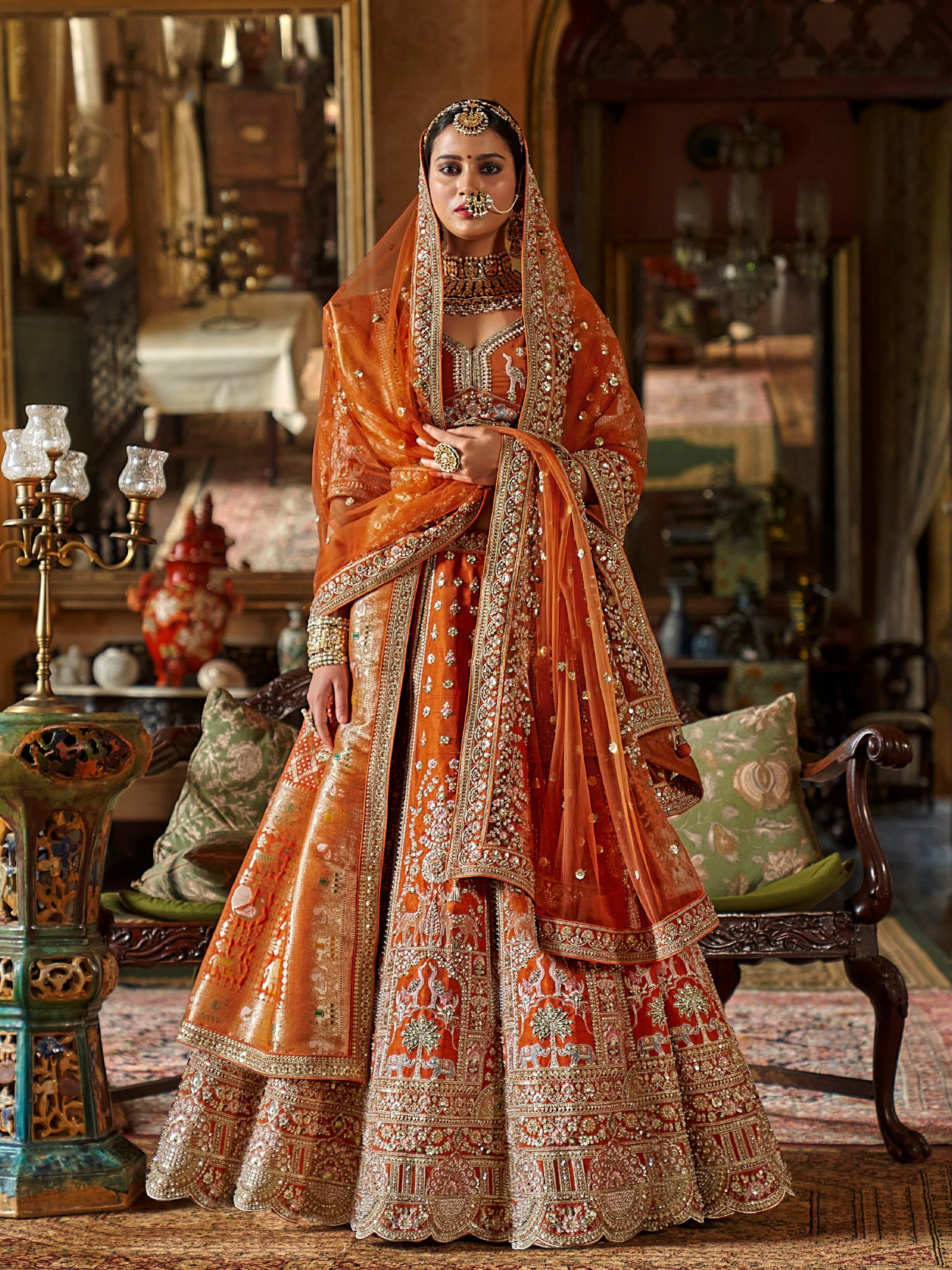 Designer orange lehenga with zari weaving and pearls