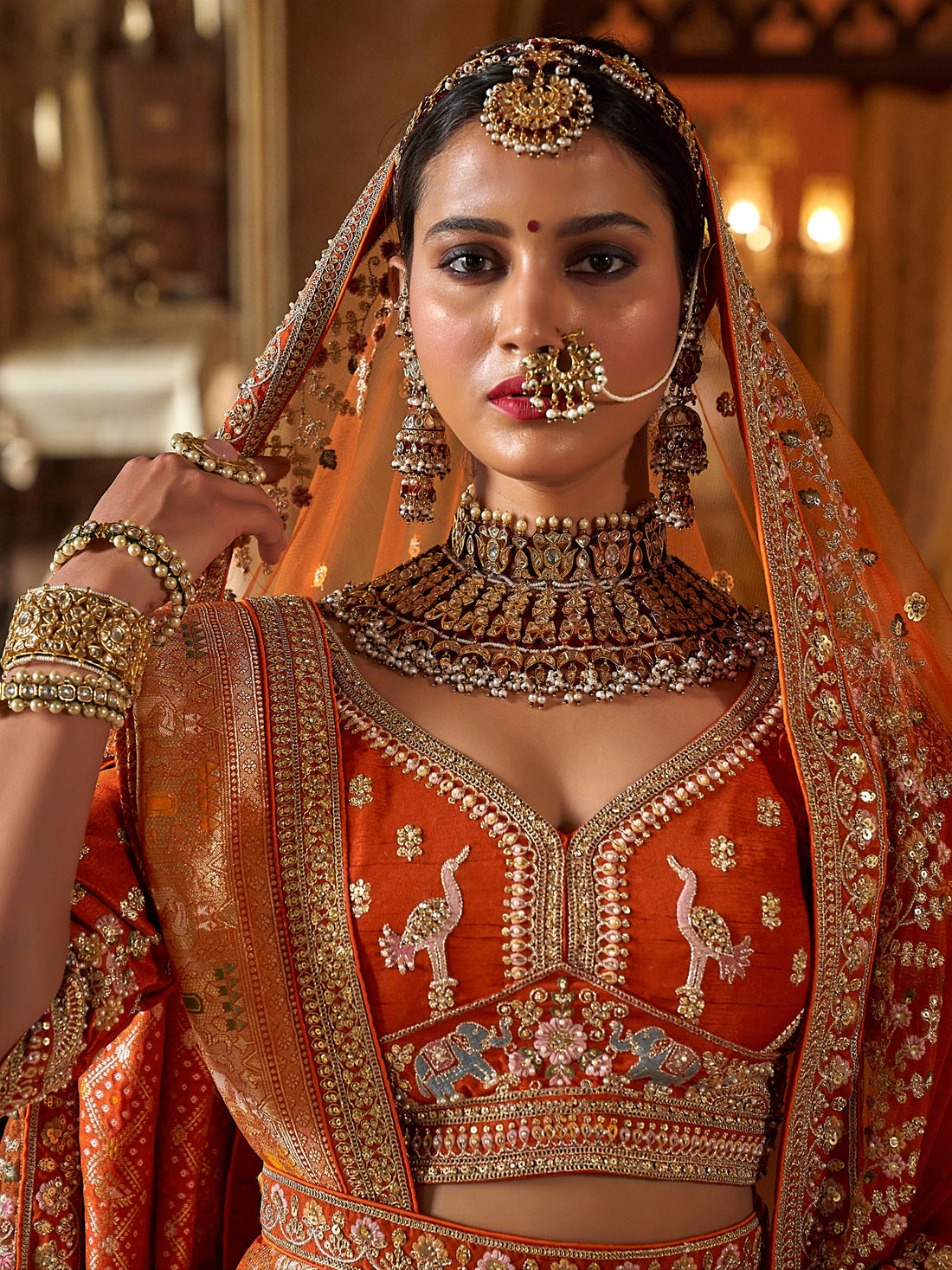 Designer orange lehenga with zari weaving and pearls