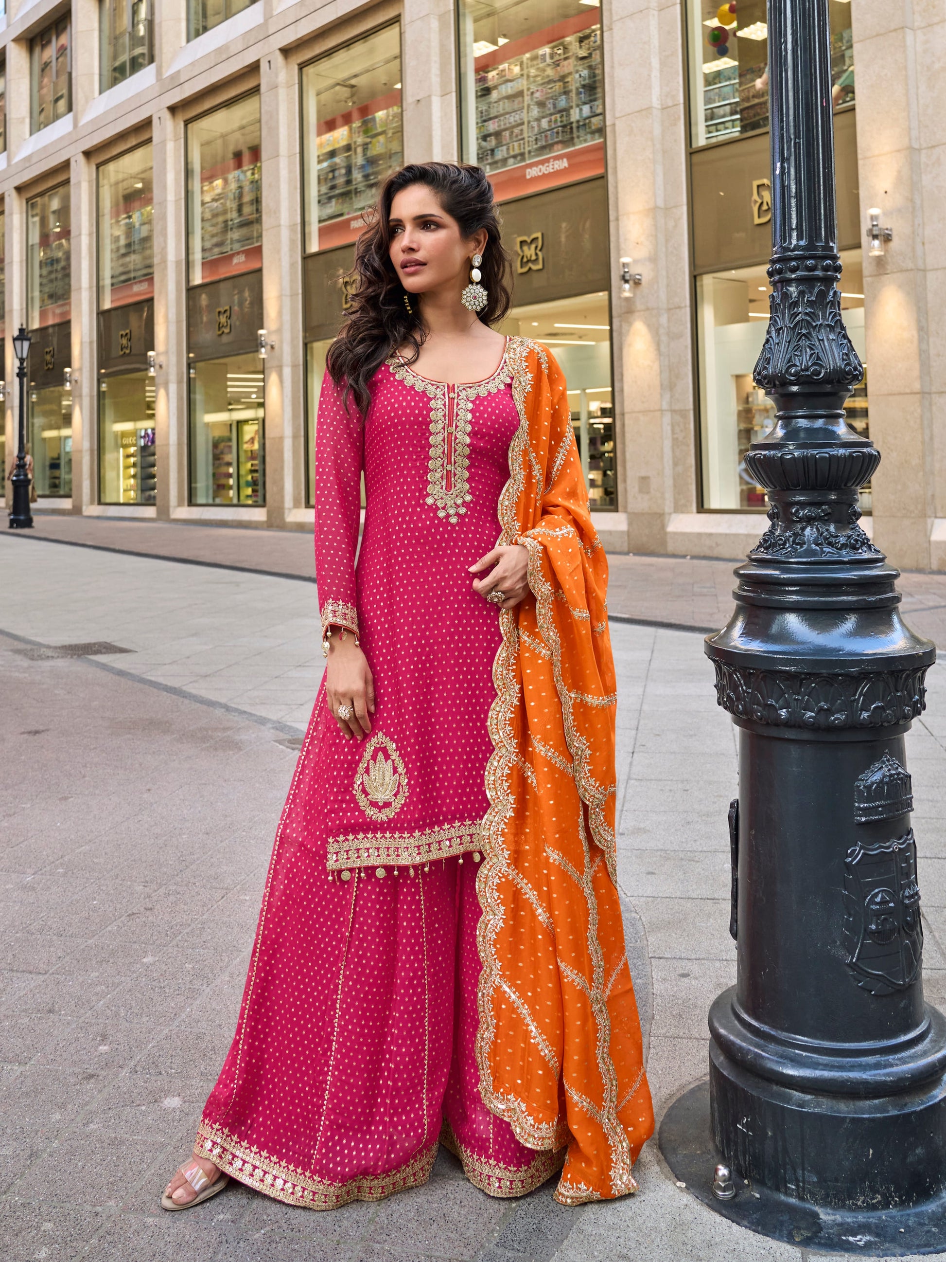 Pink embroidered sharara suit with orange dupatta for weddings