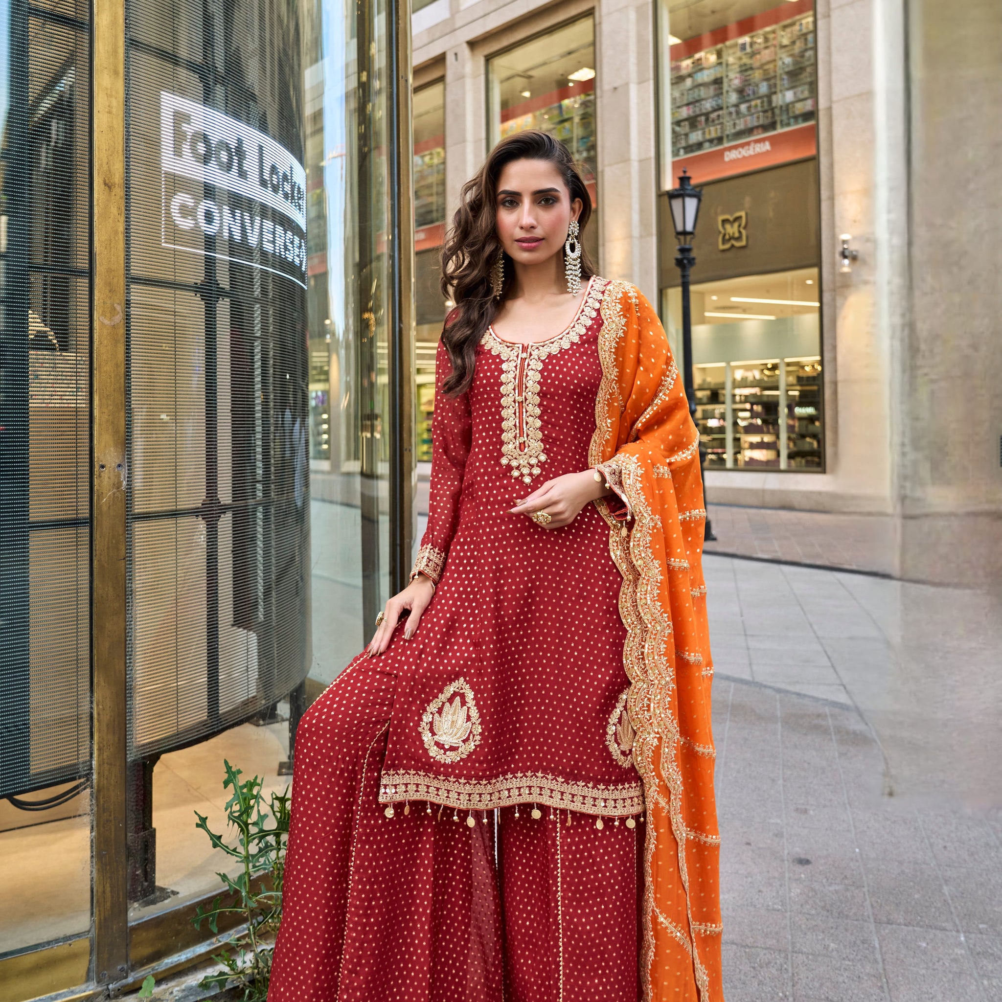 Maroon embroidered sharara suit with orange dupatta for wedding