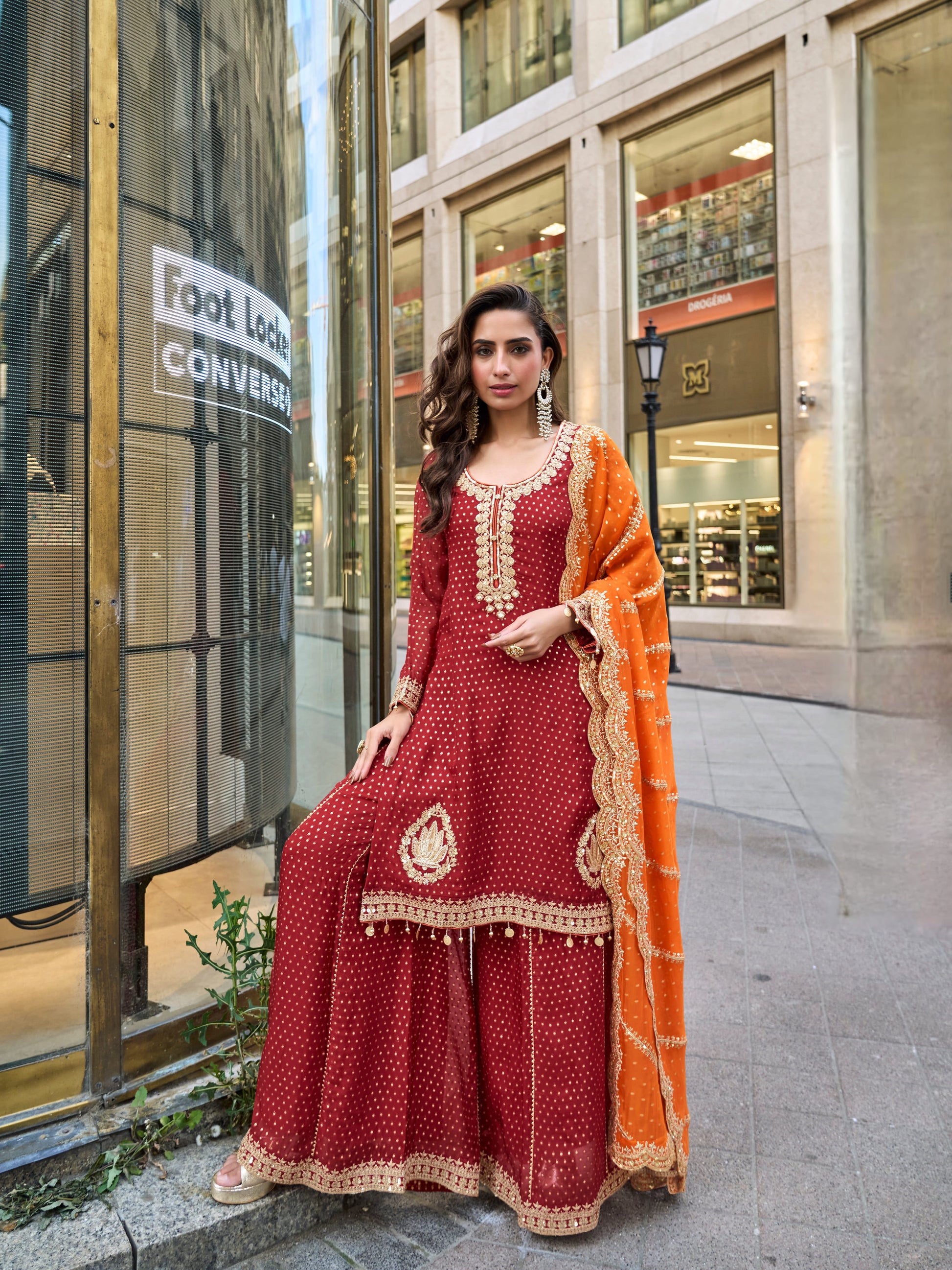 Maroon embroidered sharara suit with orange dupatta for wedding