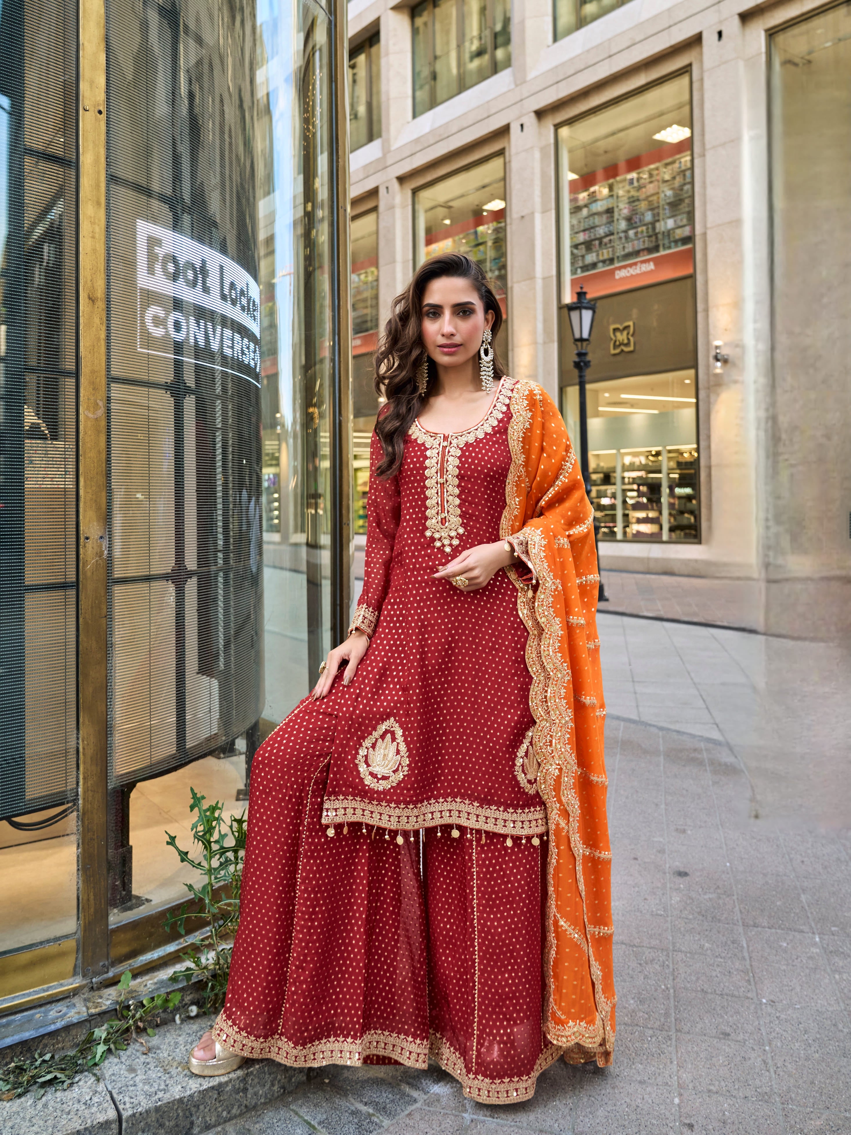 Maroon embroidered sharara suit with orange dupatta for wedding