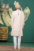 Traditional Indian groom outfit in blush pink silk