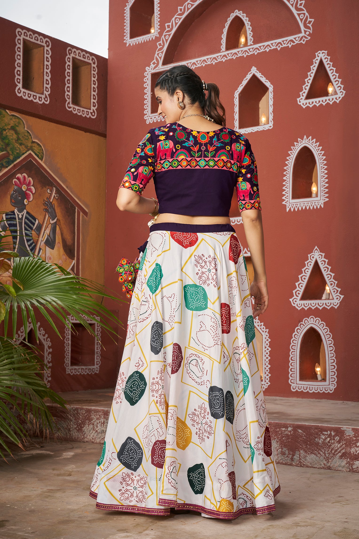 Model in white Navratri Chaniya Choli twirling during Dandiya

