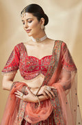 Designer lehenga choli in rich red with intricate zari embroidery and tassel details
