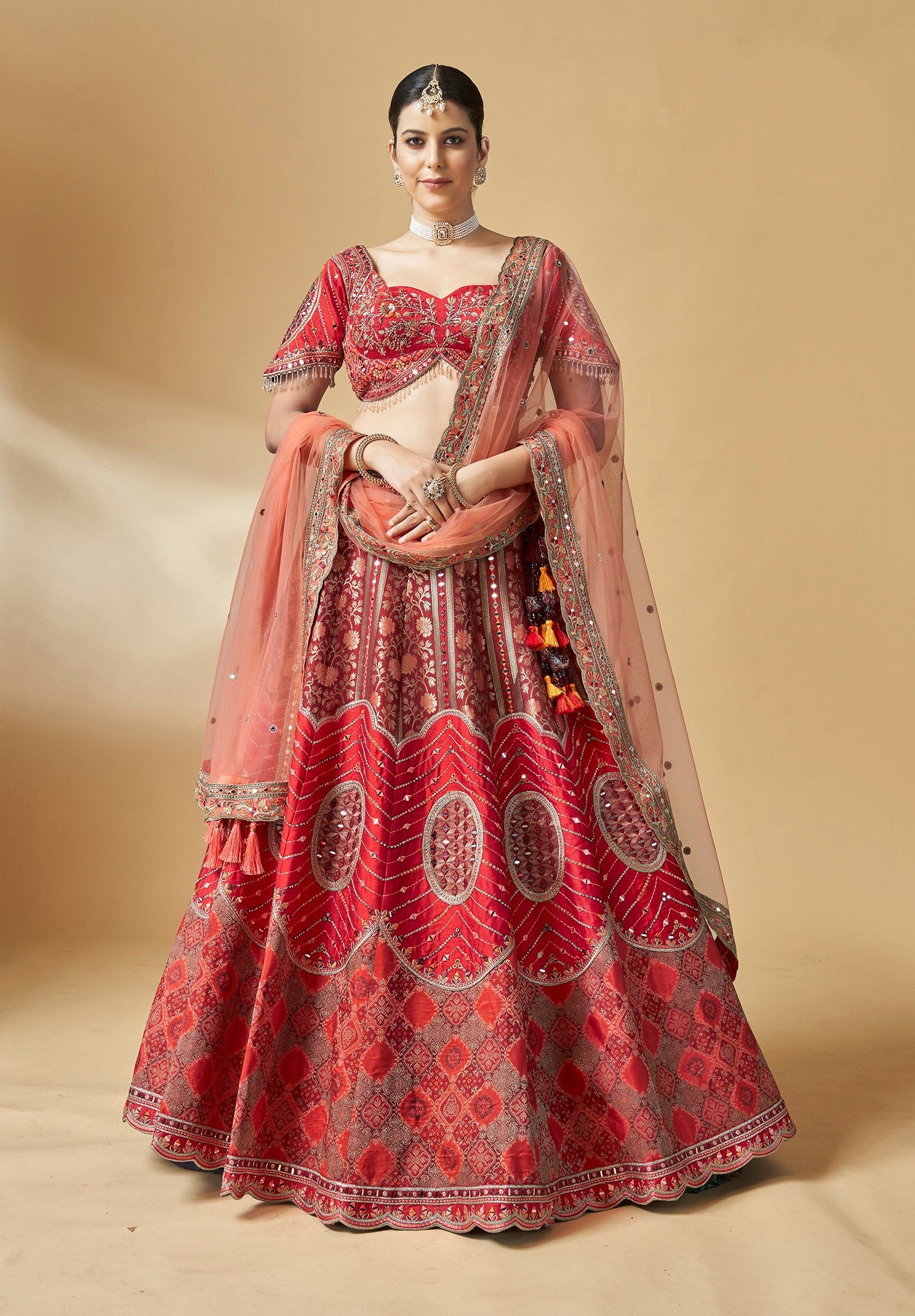 Bridal lehenga choli featuring heavy embroidery, mirror work, and traditional craftsmanship