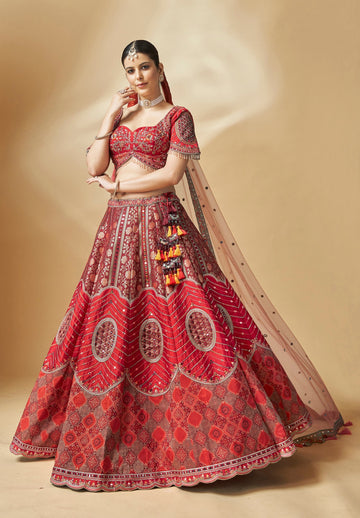 Red embroidered lehenga choli with mirror work and net dupatta – perfect for bridal and festive wear
