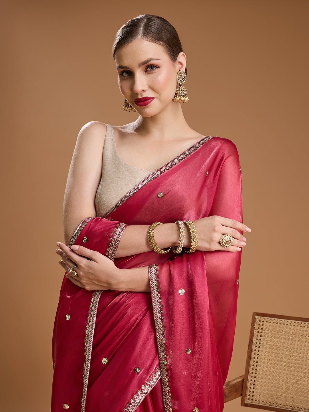Elegant pink saree with sleeveless blouse for festive occasions