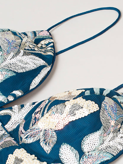 Close-up of sequins cutwork border on navy lehenga

