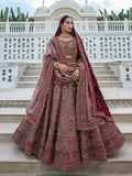 Elegant maroon and beige bridal lehenga choli with intricate embroidery.

