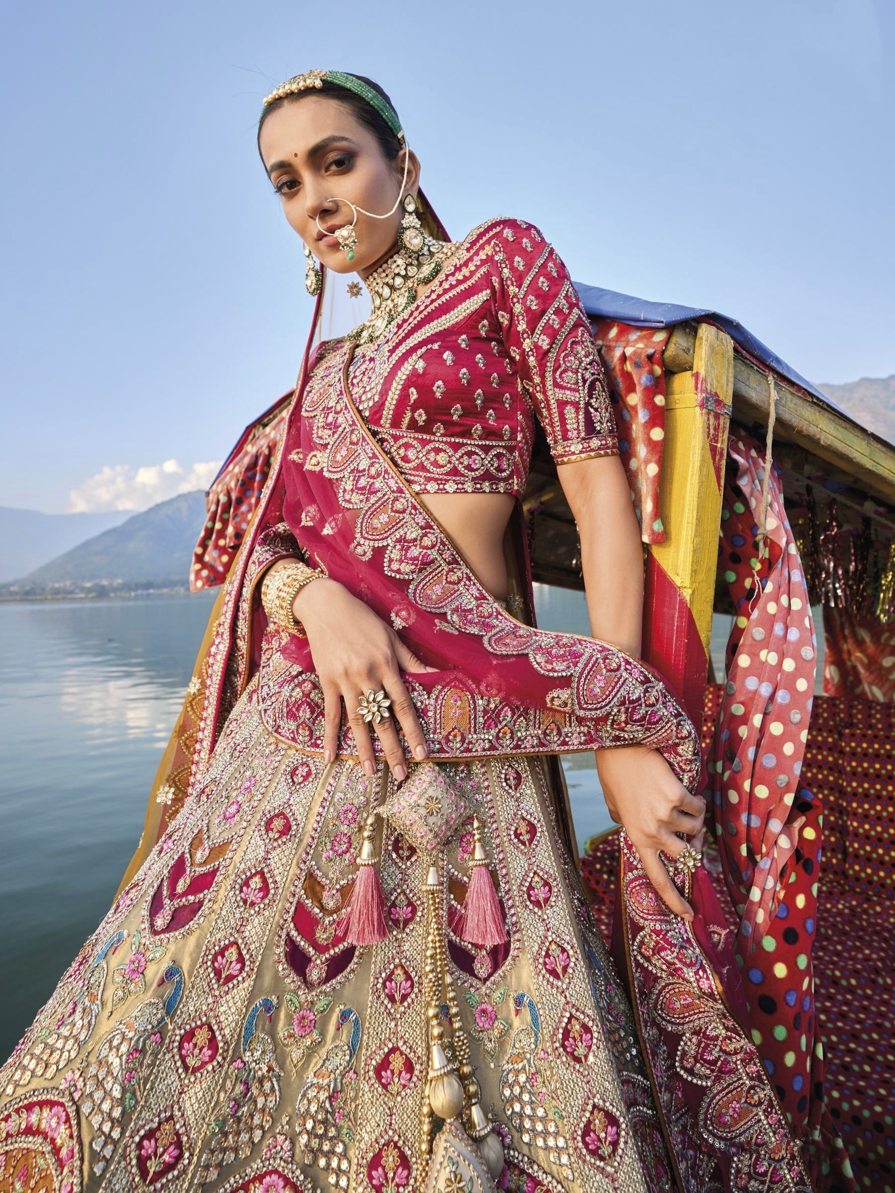 Elegant gold silk bridal lehenga with maroon embroidered blouse and dupatta.