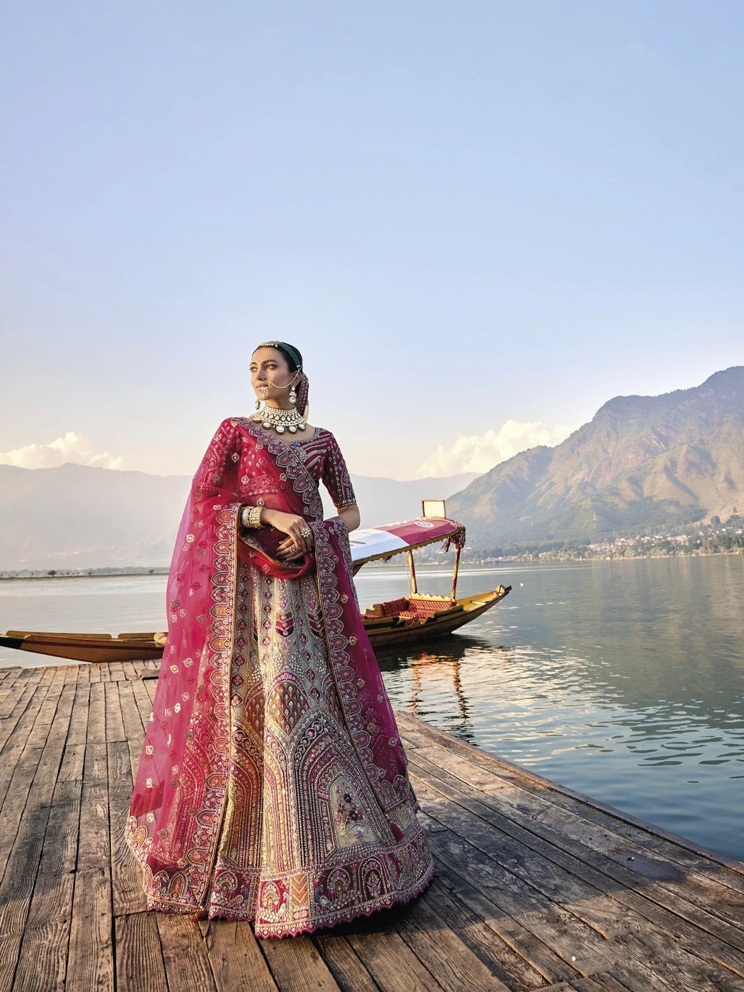 Elegant gold silk bridal lehenga with maroon embroidered blouse and dupatta.