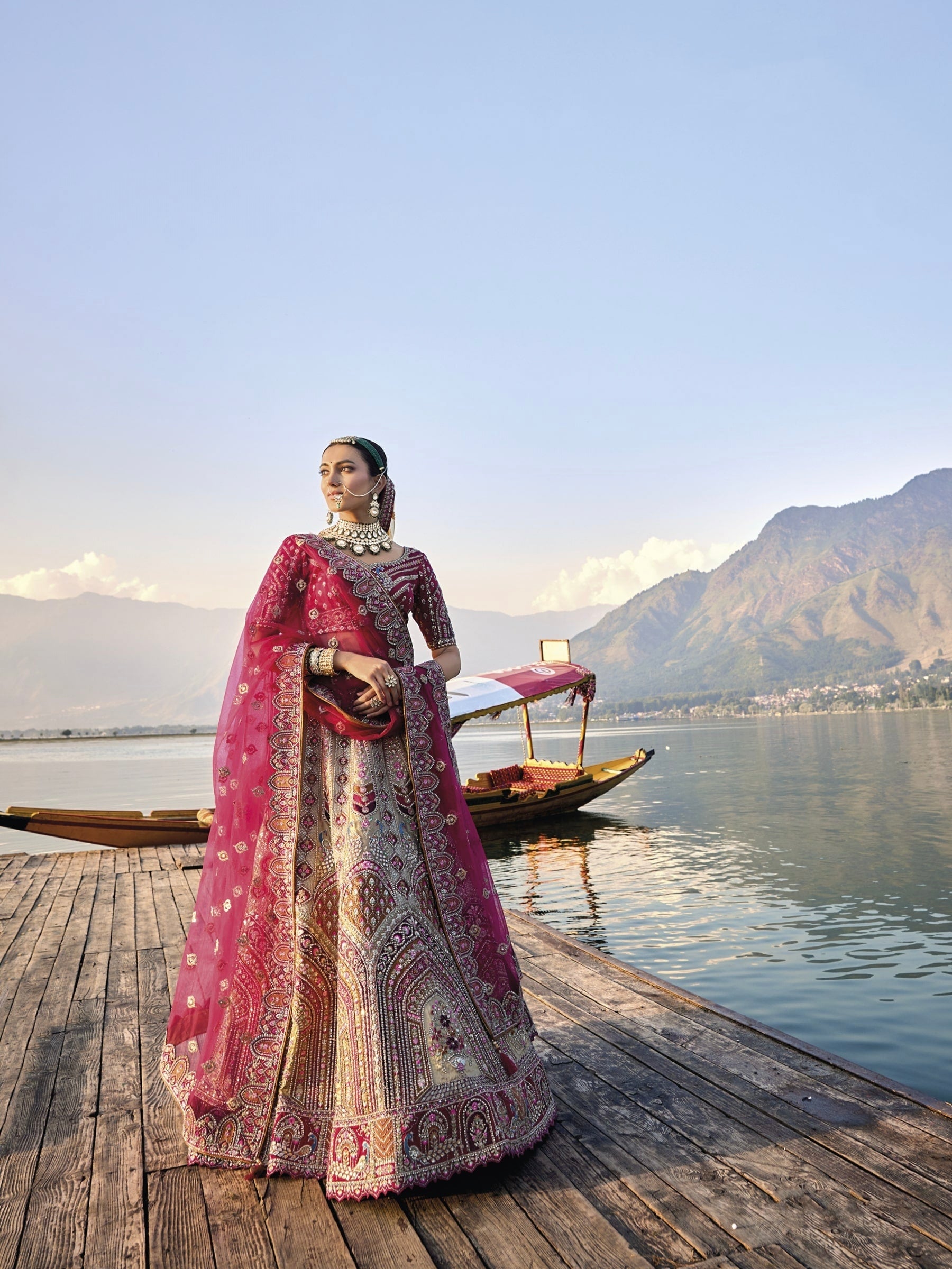 Elegant gold silk bridal lehenga with maroon embroidered blouse and dupatta.