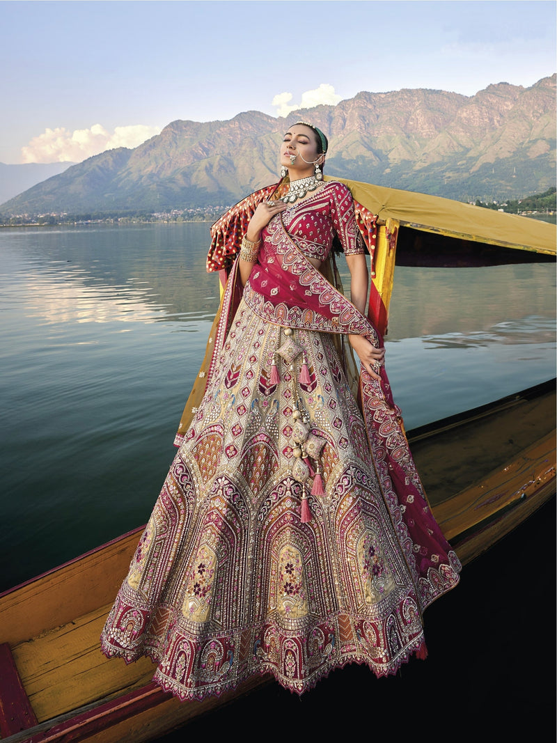 Elegant gold silk bridal lehenga with maroon embroidered blouse and dupatta.