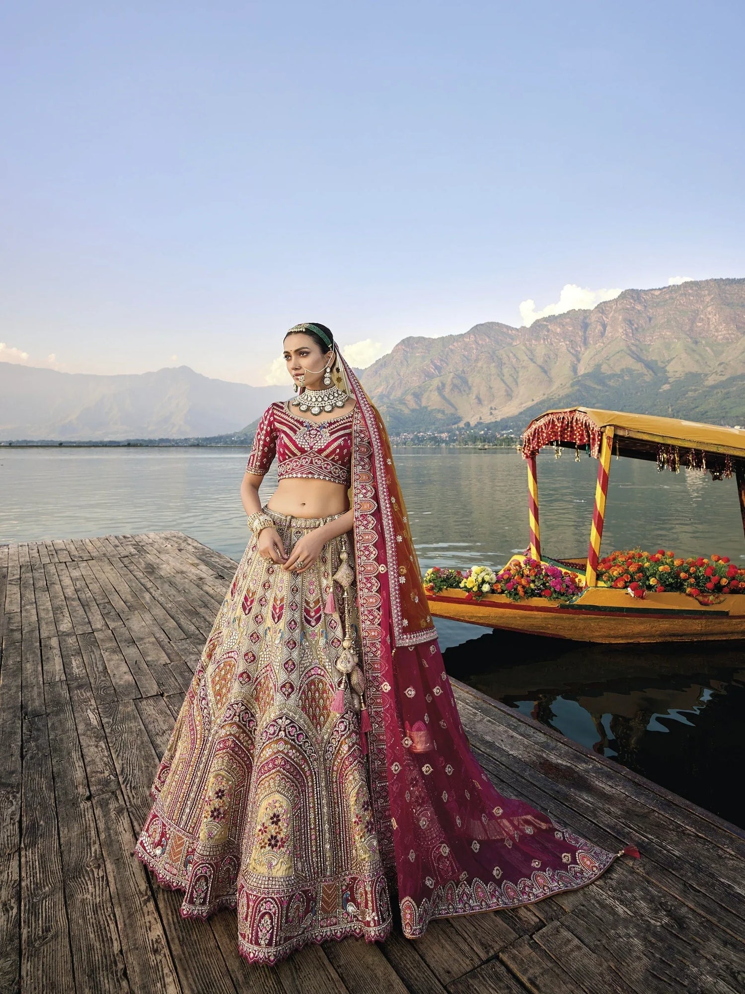 Elegant gold silk bridal lehenga with maroon embroidered blouse and dupatta.