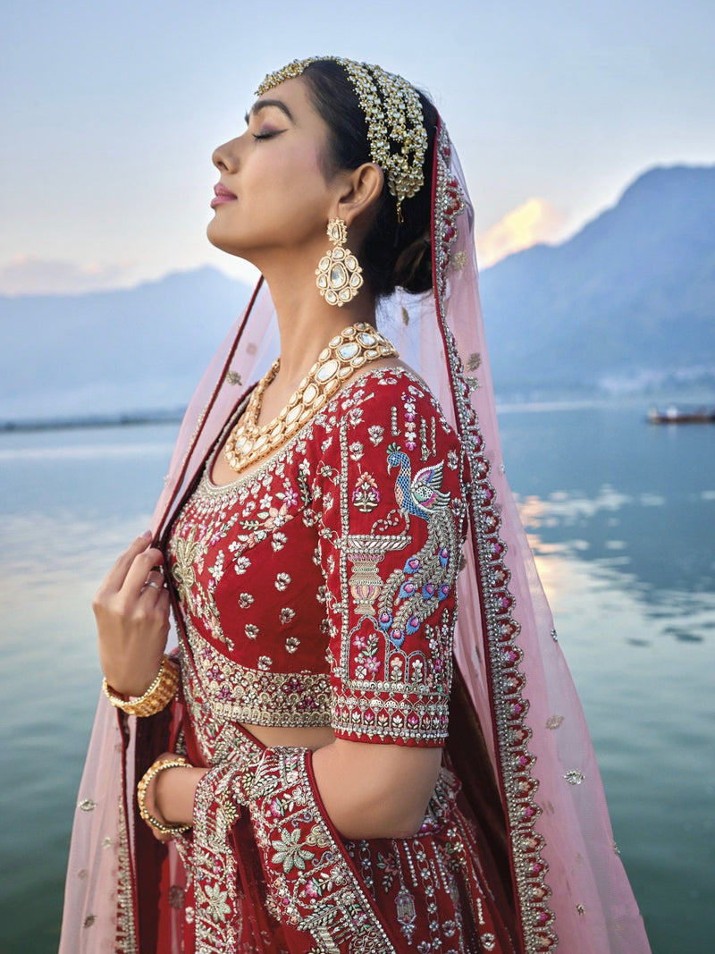 Exquisite red silk bridal lehenga with intricate embroidery and heavy net dupatta.