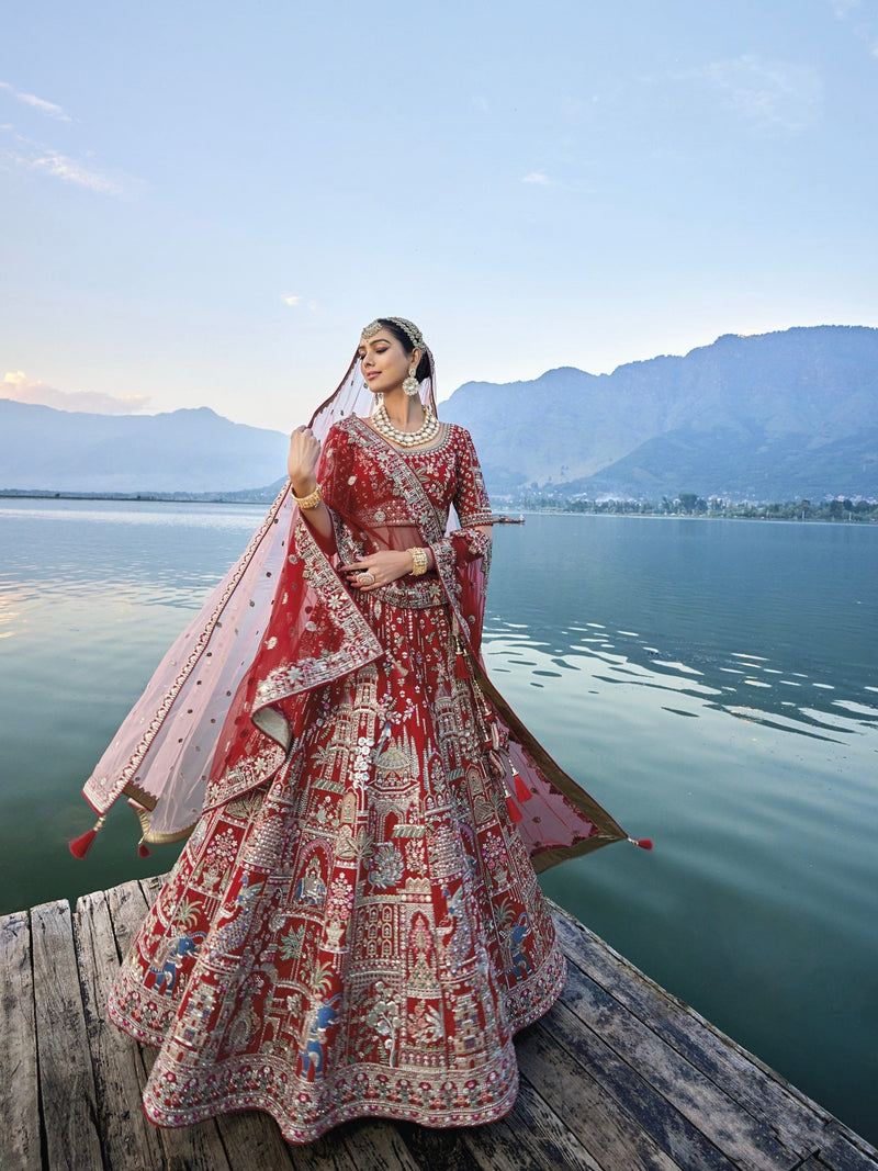 Exquisite red silk bridal lehenga with intricate embroidery and heavy net dupatta.