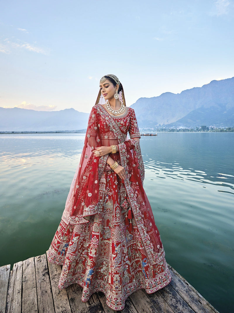 Exquisite red silk bridal lehenga with intricate embroidery and heavy net dupatta.