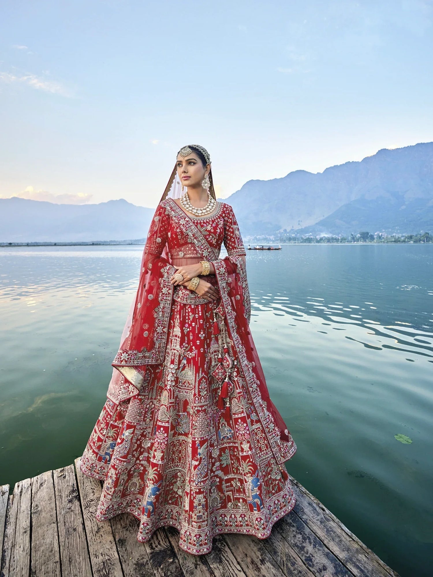 Exquisite red silk bridal lehenga with intricate embroidery and heavy net dupatta.