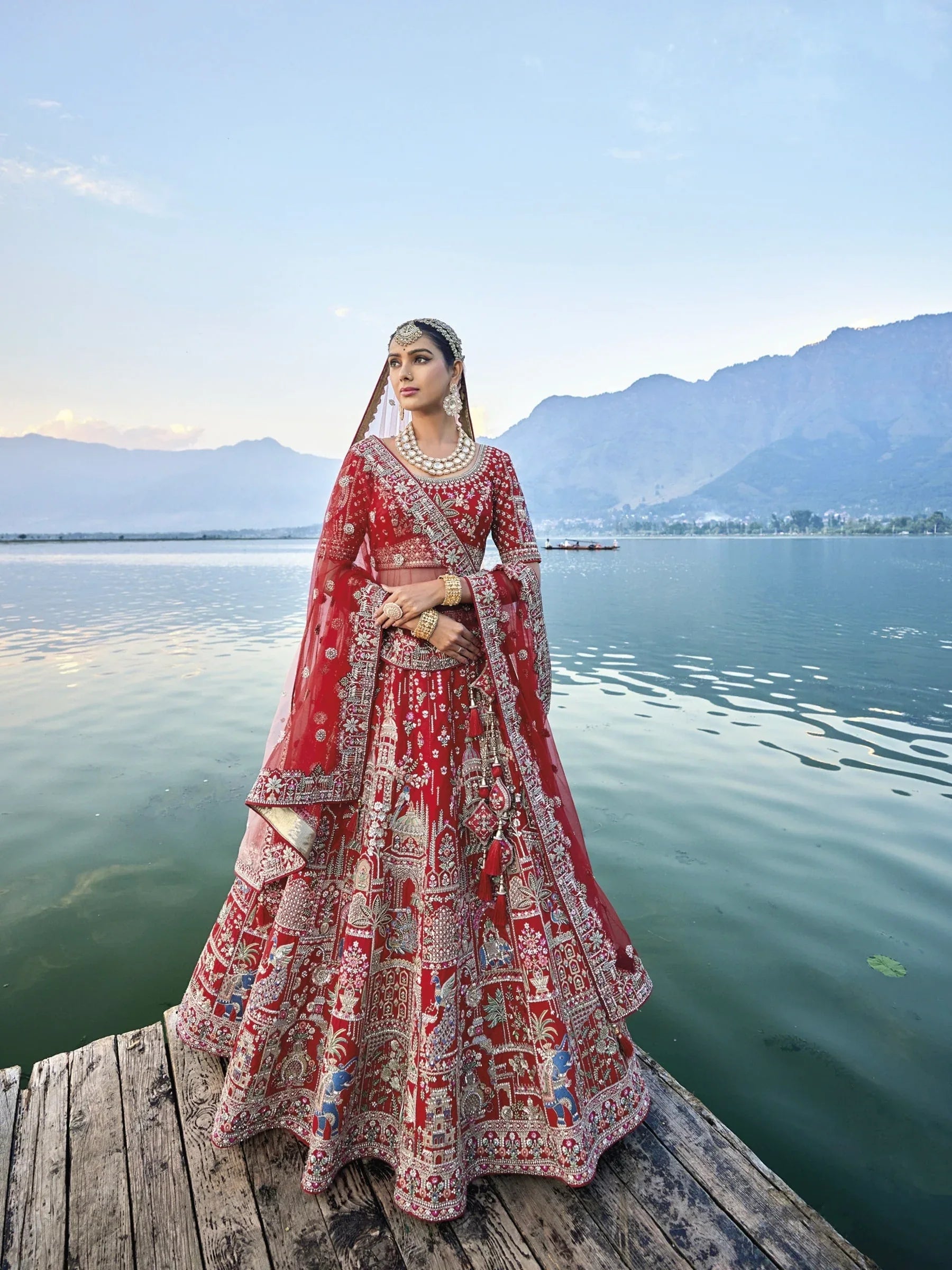 Exquisite red silk bridal lehenga with intricate embroidery and heavy net dupatta.
