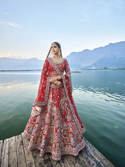 Exquisite red silk bridal lehenga with intricate embroidery and heavy net dupatta.