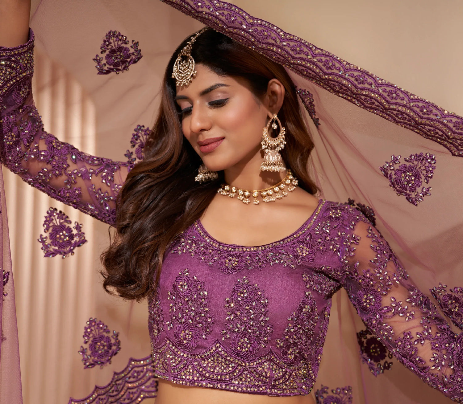 Elegant dark orchid net lehenga with silk inner and thread &amp; cording embroidery.